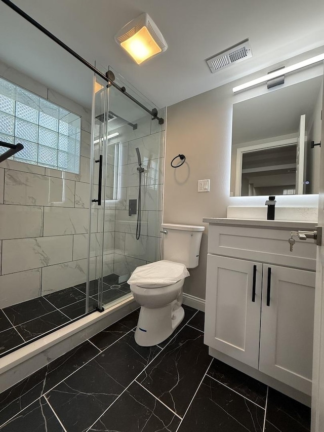 bathroom featuring toilet, vanity, and walk in shower