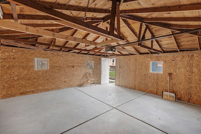 garage featuring wood walls, electric panel, and wood ceiling