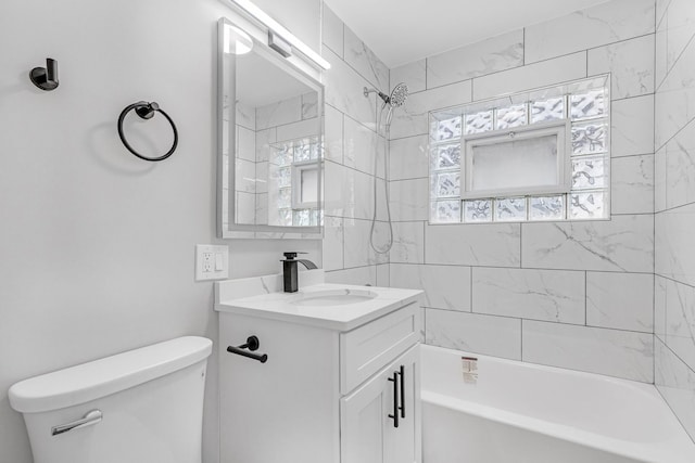 full bathroom with toilet, tiled shower / bath combo, and vanity