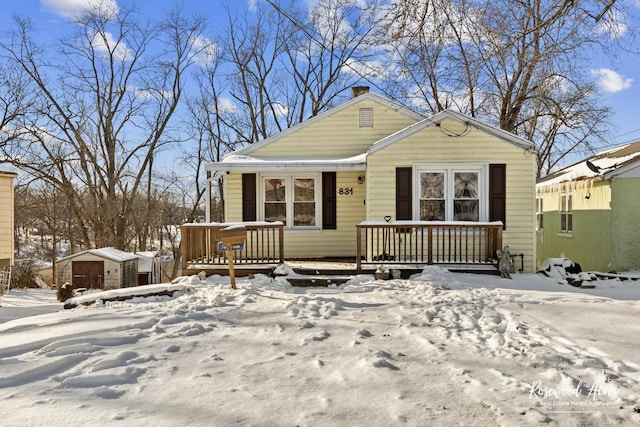 bungalow-style house featuring a shed