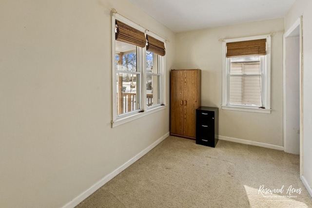 unfurnished room featuring light colored carpet