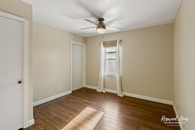 unfurnished bedroom with ceiling fan and dark wood-type flooring