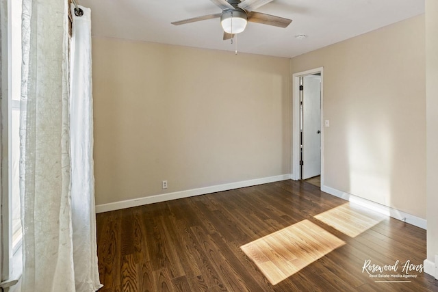 spare room featuring ceiling fan and dark wood-type flooring