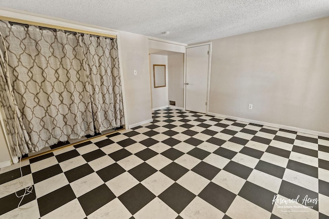 spare room featuring a textured ceiling