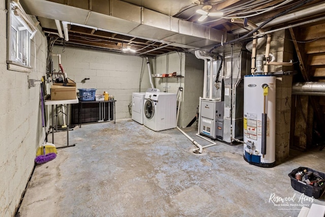 basement with heating unit, water heater, and separate washer and dryer