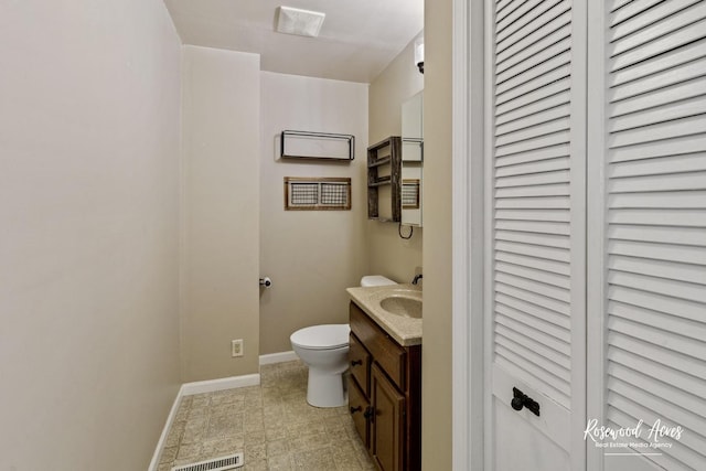 bathroom featuring toilet and vanity