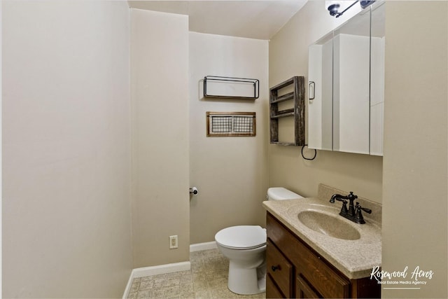 bathroom featuring toilet and vanity