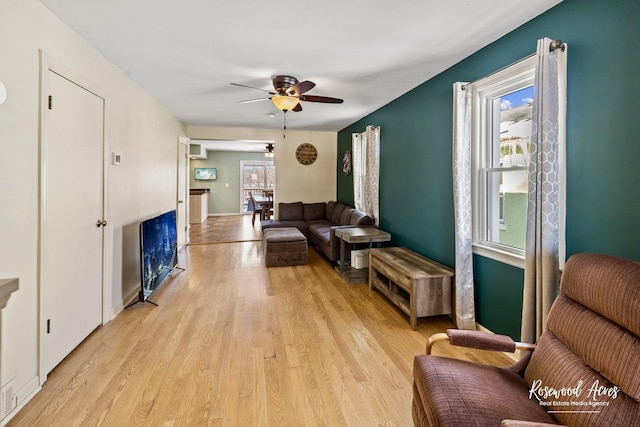 living room with ceiling fan and light hardwood / wood-style floors