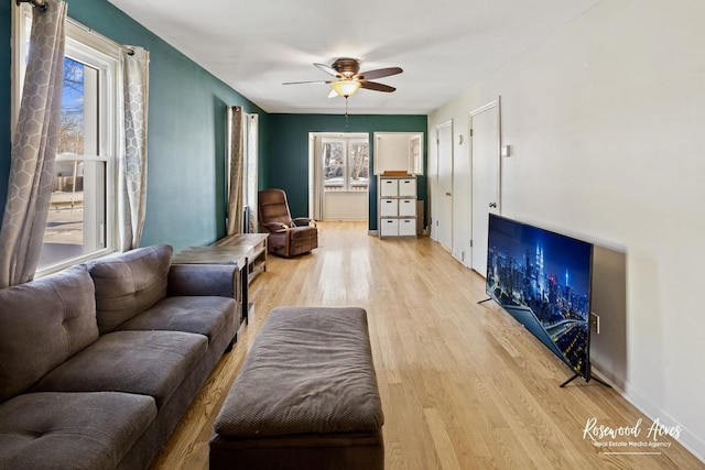 living room featuring ceiling fan and light hardwood / wood-style flooring