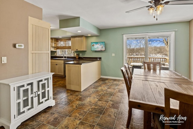 kitchen featuring ceiling fan, sink, and light brown cabinets