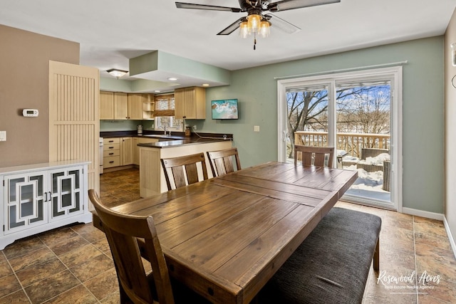 dining room with ceiling fan and sink