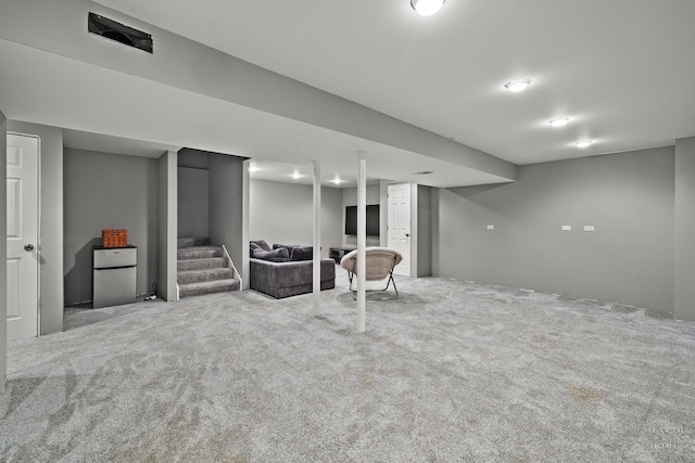 basement featuring light colored carpet