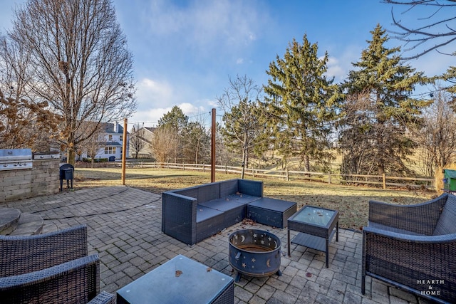 view of patio / terrace with grilling area, area for grilling, and an outdoor living space with a fire pit