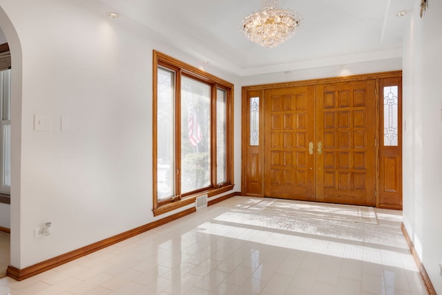 tiled entrance foyer featuring a chandelier