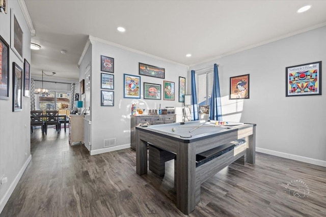 recreation room with crown molding and dark hardwood / wood-style floors