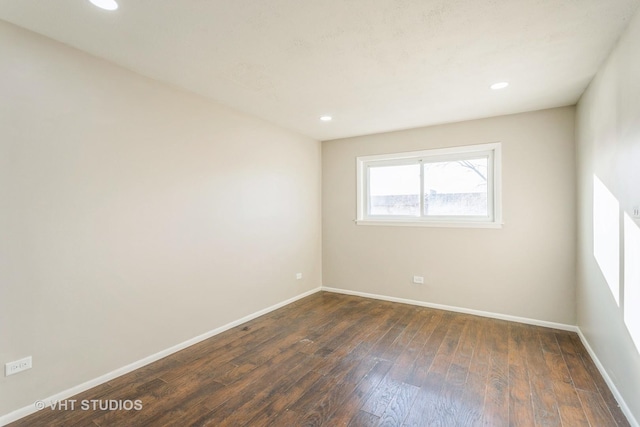 spare room featuring dark hardwood / wood-style flooring