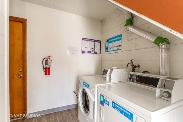 laundry area with dark hardwood / wood-style flooring and washer and clothes dryer