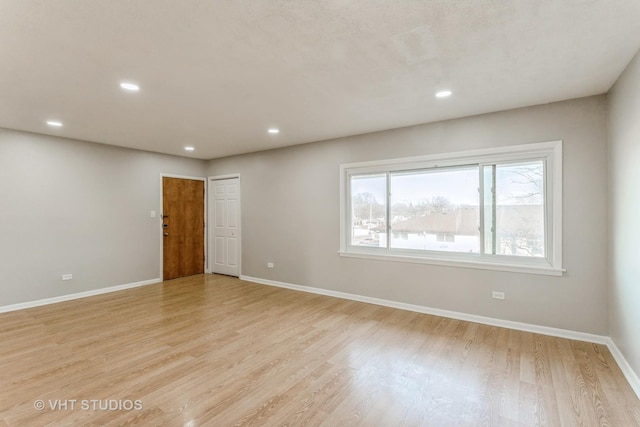 spare room featuring light wood-type flooring