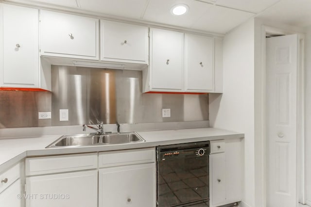 kitchen with white cabinetry, dishwasher, and sink