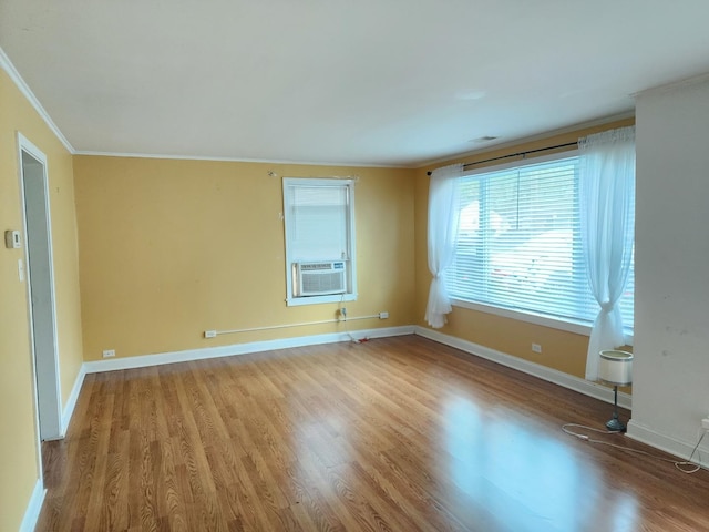 spare room with ornamental molding, light hardwood / wood-style flooring, and cooling unit