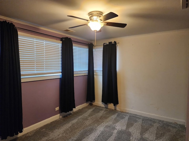 carpeted spare room featuring ceiling fan and ornamental molding