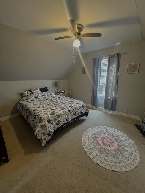 carpeted bedroom featuring lofted ceiling and ceiling fan