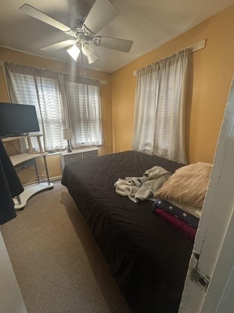 carpeted bedroom with ceiling fan