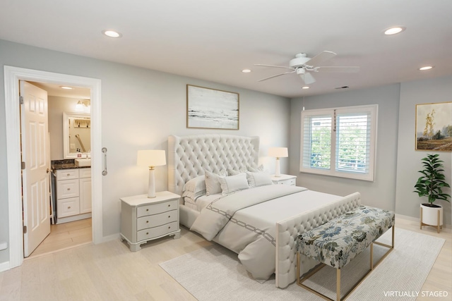 bedroom featuring ceiling fan, light hardwood / wood-style floors, and ensuite bathroom