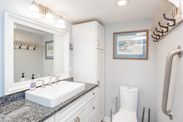 bathroom featuring toilet and vanity