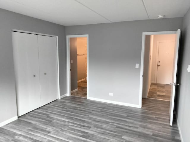 unfurnished bedroom with a closet and wood-type flooring