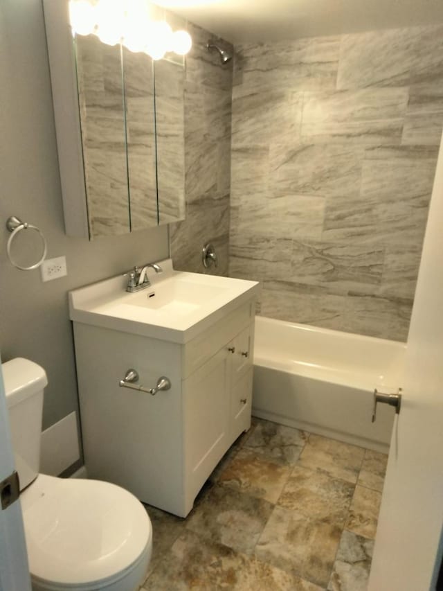 full bathroom with toilet, tiled shower / bath combo, and vanity