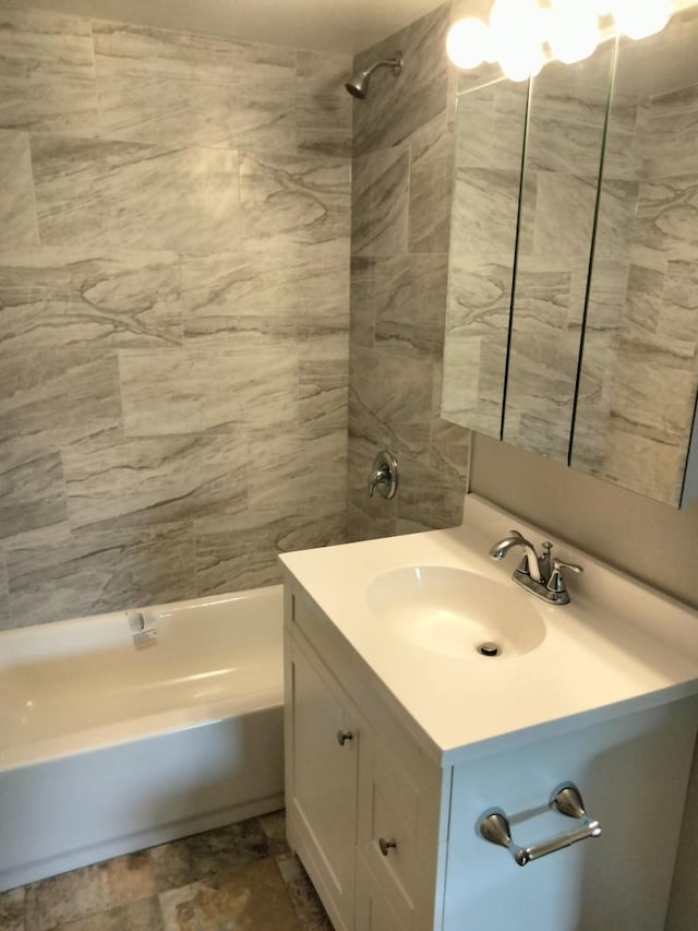 bathroom with vanity and tiled shower / bath