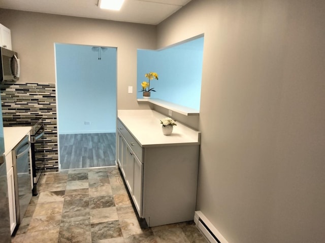 bathroom with a baseboard radiator and tasteful backsplash