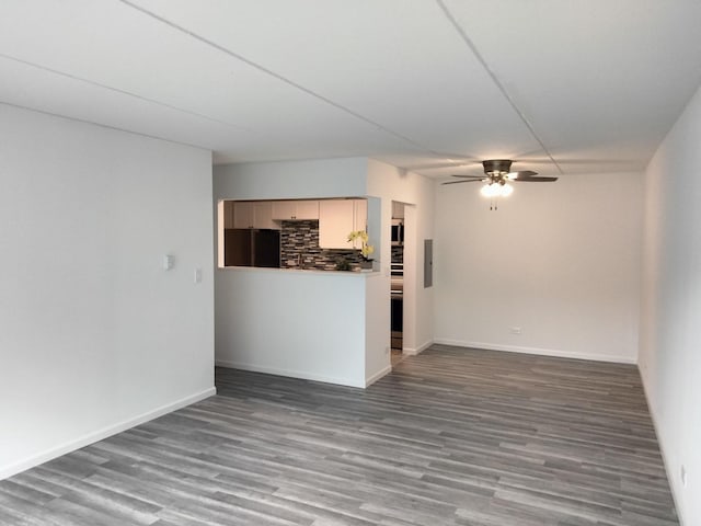 unfurnished living room with ceiling fan and dark hardwood / wood-style floors