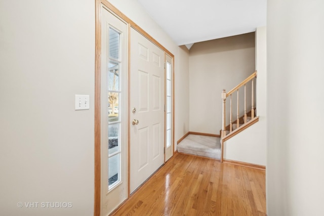 foyer entrance with light hardwood / wood-style floors