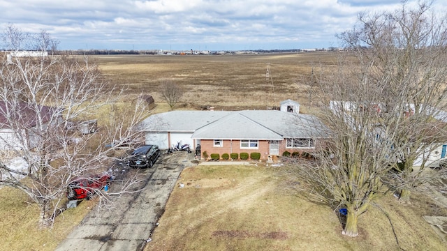 birds eye view of property with a rural view