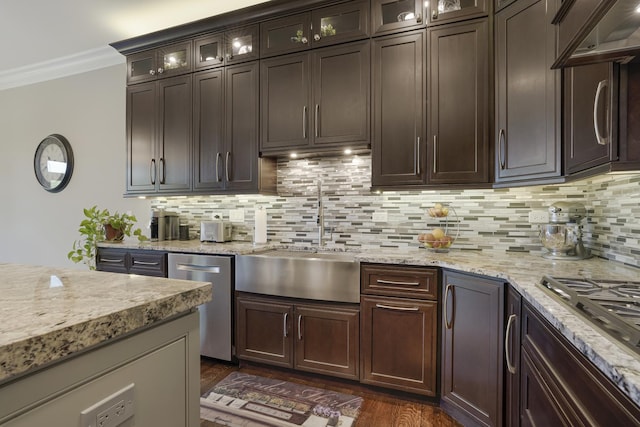 kitchen with decorative backsplash, sink, dark brown cabinetry, and stainless steel appliances