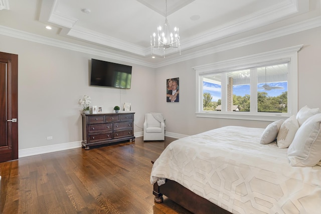 bedroom featuring dark hardwood / wood-style floors, a tray ceiling, ornamental molding, and a notable chandelier