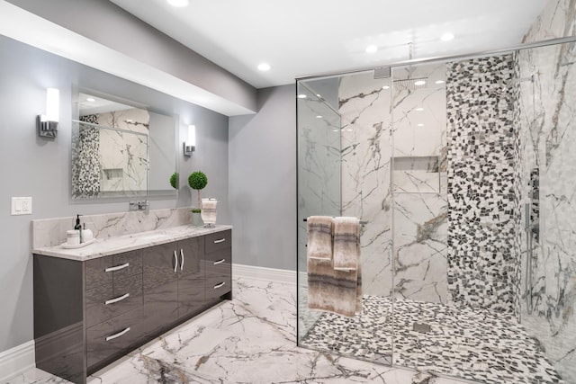 bathroom featuring a shower with door and vanity