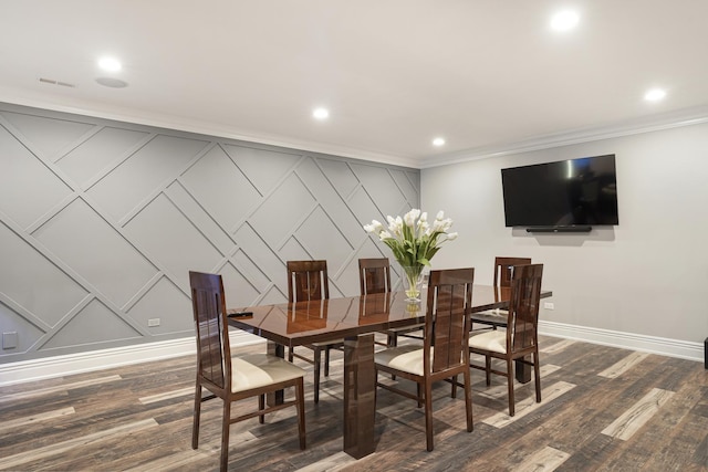 dining space with dark wood-type flooring and ornamental molding