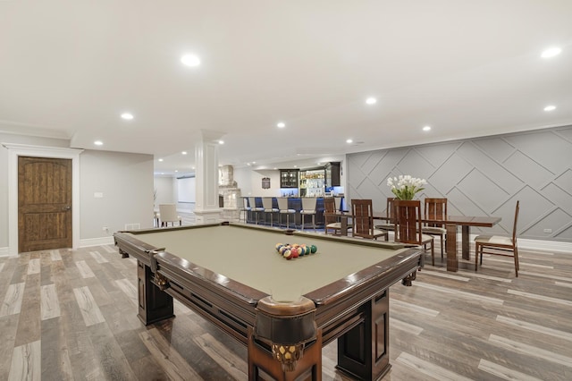 rec room with billiards, bar, and light hardwood / wood-style floors