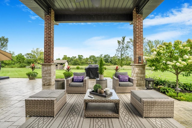 view of patio featuring ceiling fan, an outdoor living space, and grilling area