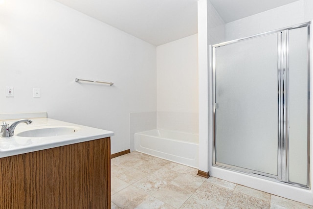 full bathroom with vanity, a garden tub, baseboards, and a stall shower