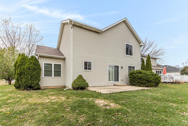 rear view of property with a patio and a yard