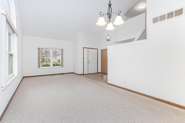 interior space featuring light carpet, a high ceiling, and a notable chandelier