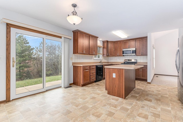 kitchen featuring tasteful backsplash, a healthy amount of sunlight, a center island, light countertops, and stainless steel appliances