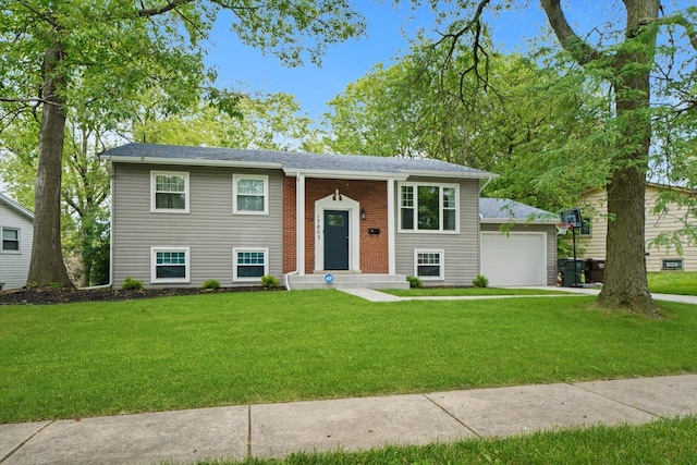 split foyer home with a front yard and a garage