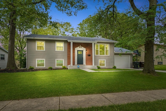 split foyer home featuring a front yard and a garage