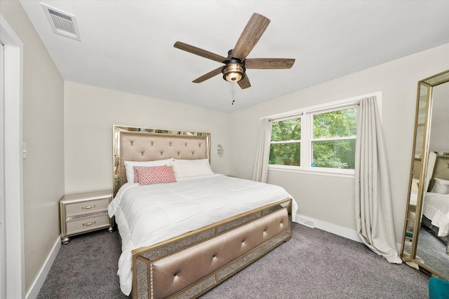 bedroom with ceiling fan and dark carpet