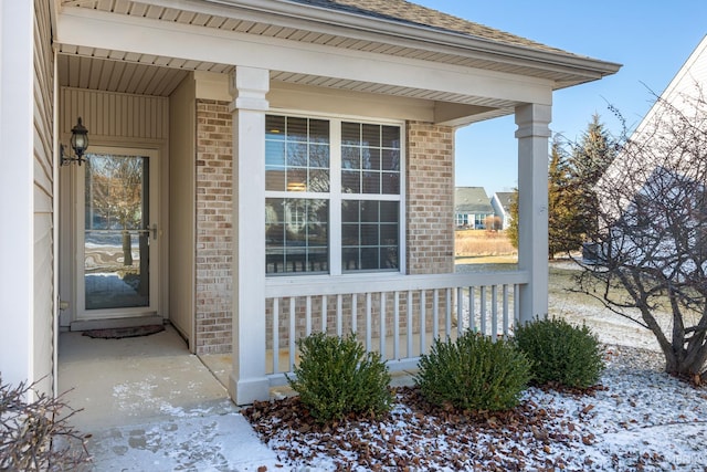 view of snow covered property entrance